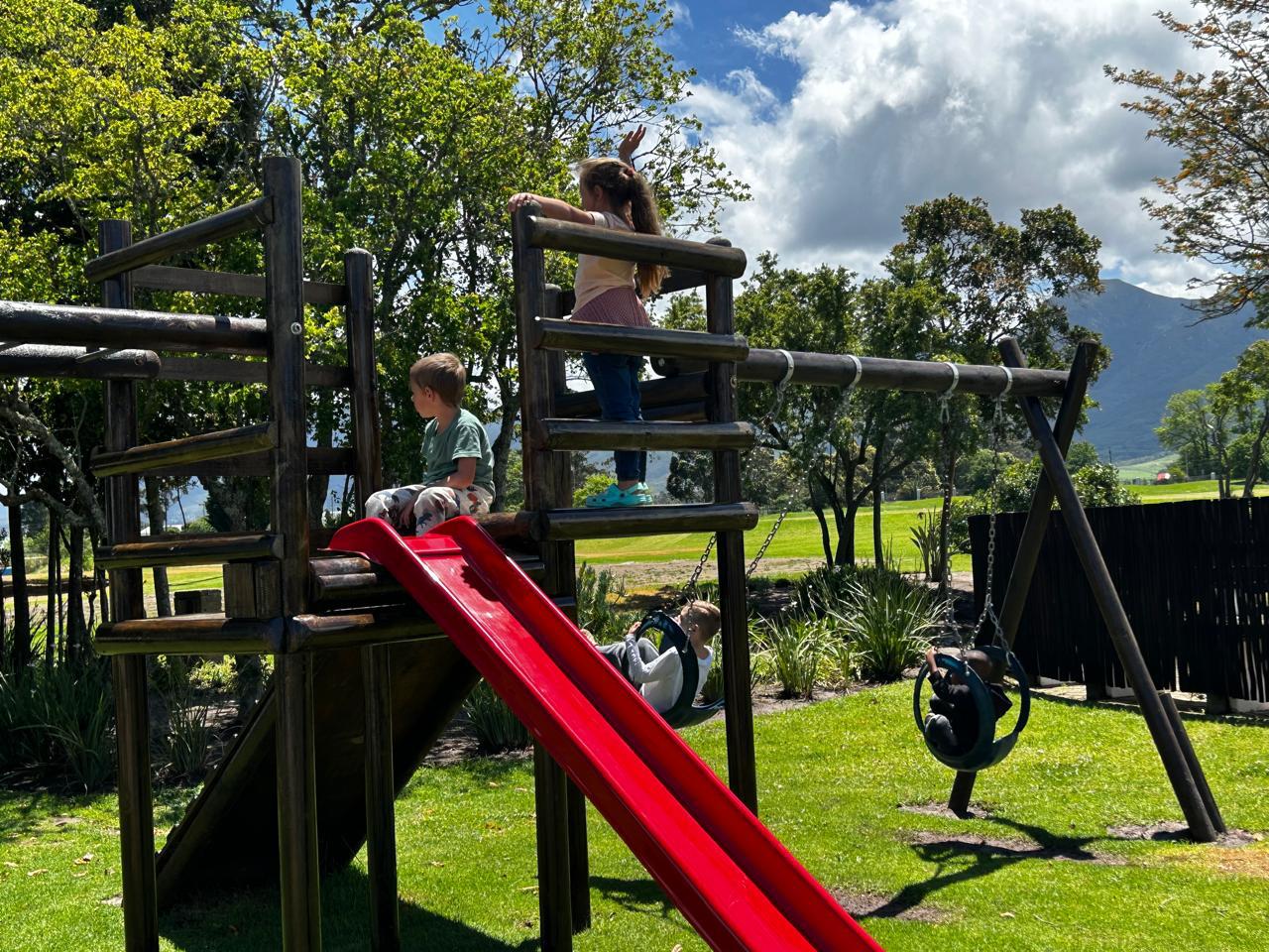 Children's playground area with slides and swings