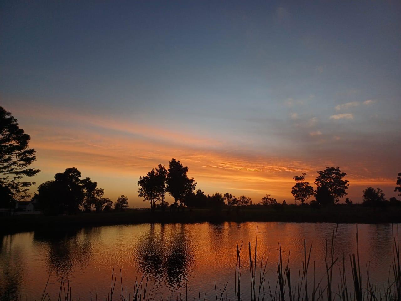 Peaceful sunset reflection over the lake near school campus